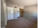 Bedroom showcasing plush carpet, closet with organizers, and warm, neutral color scheme at 2515 S Maple Ave # 103, Tempe, AZ 85282