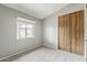 Bright bedroom with a large window and wood sliding door closet at 2515 S Maple Ave # 103, Tempe, AZ 85282