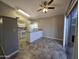 Bright kitchen features white appliances, tile flooring, and access to outdoor patio at 2515 S Maple Ave # 103, Tempe, AZ 85282