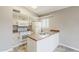 Bright kitchen with white appliances, neutral cabinets, and a peninsula with a double sink at 2515 S Maple Ave # 103, Tempe, AZ 85282