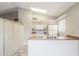 Kitchen with an island and ample cabinet space, featuring all-white appliances at 2515 S Maple Ave # 103, Tempe, AZ 85282