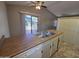 Functional kitchen with stainless steel sink, wooden countertops, and sliding glass door to patio at 2515 S Maple Ave # 103, Tempe, AZ 85282