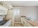 Kitchen featuring ample cabinet space, a window, white appliances, and laminate countertops at 2515 S Maple Ave # 103, Tempe, AZ 85282