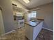 Kitchen with bright natural light, featuring an island sink and modern appliances at 2515 S Maple Ave # 103, Tempe, AZ 85282
