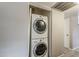 Efficient laundry closet featuring a stacked washer and dryer for space-saving convenience at 2515 S Maple Ave # 103, Tempe, AZ 85282