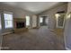 Carpeted living room features brick fireplace, picture window, and open view to the entry at 2515 S Maple Ave # 103, Tempe, AZ 85282