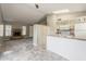 Open living space with a cozy fireplace and adjacent kitchen area at 2515 S Maple Ave # 103, Tempe, AZ 85282