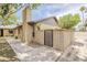 Brick home exterior showing a gated side entrance, chimney and partial view of the roofline at 2515 S Maple Ave # 103, Tempe, AZ 85282