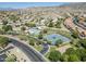 Aerial view of a neighborhood park with a pool, tennis courts, and a playground at 2629 E Verbena Dr, Phoenix, AZ 85048