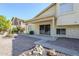 Backyard view showcasing a covered patio and desert landscaping with mature plants at 2629 E Verbena Dr, Phoenix, AZ 85048