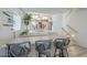 Stylish wet bar with barstool seating and views into the dining room and kitchen, perfect for entertaining at 2629 E Verbena Dr, Phoenix, AZ 85048
