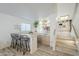 Stylish wet bar with barstool seating, sink, and cabinet storage for entertaining guests at 2629 E Verbena Dr, Phoenix, AZ 85048