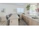 Stylish wet bar with barstool seating, sink, and cabinet storage next to the kitchen and stairs at 2629 E Verbena Dr, Phoenix, AZ 85048