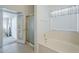 Bright bathroom featuring a built-in tub and french doors to an adjoining room at 2629 E Verbena Dr, Phoenix, AZ 85048