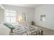 Relaxing bedroom bathed in light with a stylish bedspread and well-placed decor at 2629 E Verbena Dr, Phoenix, AZ 85048