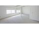 Sunlit bedroom features window, closet with mirrored doors, and neutral carpet at 2629 E Verbena Dr, Phoenix, AZ 85048