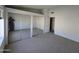 Spacious bedroom featuring a large mirrored closet and neutral carpet at 2629 E Verbena Dr, Phoenix, AZ 85048