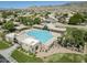 Aerial view showcasing the community pool with ample seating and shaded areas against a mountain backdrop at 2629 E Verbena Dr, Phoenix, AZ 85048