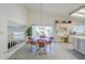 Dining area adjacent to the kitchen featuring a glass-top table, four chairs, and sliding glass door at 2629 E Verbena Dr, Phoenix, AZ 85048