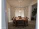 Dining room with a classic chandelier, a large window, and seating for six at 2629 E Verbena Dr, Phoenix, AZ 85048