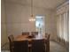 Dining room featuring a traditional chandelier, a window, and a view into the kitchen at 2629 E Verbena Dr, Phoenix, AZ 85048