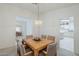 Dining area featuring a wood table with views into the living room and kitchen, promoting a sense of openness at 2629 E Verbena Dr, Phoenix, AZ 85048