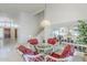 Bright dining room with red cushioned seating, glass-top table and staircase at 2629 E Verbena Dr, Phoenix, AZ 85048