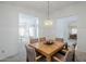 Open dining room with a wood table and views into the living room, creating a connected and spacious living area at 2629 E Verbena Dr, Phoenix, AZ 85048