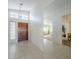 Inviting entryway with wood door, tile floor, and large mirror, leading to the main living areas at 2629 E Verbena Dr, Phoenix, AZ 85048