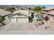 Inviting two-story home with a spacious three-car garage and xeriscaped front yard landscaping at 2629 E Verbena Dr, Phoenix, AZ 85048
