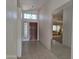 Entryway with tile flooring, a decorative light fixture, and a view into the spacious living room at 2629 E Verbena Dr, Phoenix, AZ 85048