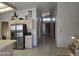 Efficient kitchen with stainless steel refrigerator and tile countertops at 2629 E Verbena Dr, Phoenix, AZ 85048