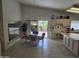 Open kitchen with dining area, tile floors, vaulted ceilings and slider doors at 2629 E Verbena Dr, Phoenix, AZ 85048