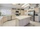 Eat-in kitchen with stainless steel appliances, neutral cabinets, tile counters and flooring, and recessed lighting at 2629 E Verbena Dr, Phoenix, AZ 85048