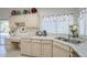 Bright kitchen featuring stainless steel appliances, light wood cabinets, tile countertops, and a sink at 2629 E Verbena Dr, Phoenix, AZ 85048