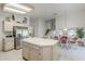 Open kitchen with island, stainless steel refrigerator, tile countertops and breakfast nook with seating at 2629 E Verbena Dr, Phoenix, AZ 85048