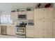 Bright kitchen featuring stainless steel appliances, light wood cabinets and tile countertops and backsplash at 2629 E Verbena Dr, Phoenix, AZ 85048