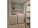 Laundry room with washer, dryer, shelving, and ample storage space at 2629 E Verbena Dr, Phoenix, AZ 85048