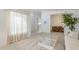Bright living room with large window, carpet, neutral paint, and a glimpse of the adjacent dining area and kitchen at 2629 E Verbena Dr, Phoenix, AZ 85048