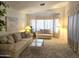 Inviting living room with large bay window providing ample natural light and neutral décor at 2629 E Verbena Dr, Phoenix, AZ 85048