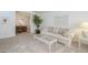 Bright living room with carpet, neutral paint, glass coffee table, and an adjacent dining area, creating an inviting space at 2629 E Verbena Dr, Phoenix, AZ 85048