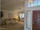 Bright living room featuring comfortable seating, neutral color scheme, and a view of the front door at 2629 E Verbena Dr, Phoenix, AZ 85048