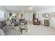 Cozy living room featuring plush sofas, a glass coffee table, and open floor plan at 2629 E Verbena Dr, Phoenix, AZ 85048