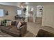 Comfortable living room with plush seating, breakfast bar, and an open floor plan leading to kitchen at 2629 E Verbena Dr, Phoenix, AZ 85048