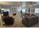 Spacious living room with fireplace, ceiling fans, and comfortable seating at 2629 E Verbena Dr, Phoenix, AZ 85048
