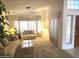 Bright living room featuring neutral carpet, sofas, and large windows at 2629 E Verbena Dr, Phoenix, AZ 85048