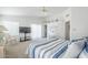 Bright bedroom with a striped blue and white bedspread and access to a patio at 2629 E Verbena Dr, Phoenix, AZ 85048
