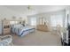 Bright main bedroom with neutral carpet, light walls, and an ensuite bathroom at 2629 E Verbena Dr, Phoenix, AZ 85048