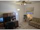 Comfortable office space features a ceiling fan, a full desk, and a cozy sofa for relaxing and working at 2629 E Verbena Dr, Phoenix, AZ 85048