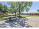 Community picnic area with shaded tables adjacent to a sandy playground and walking paths at 2629 E Verbena Dr, Phoenix, AZ 85048